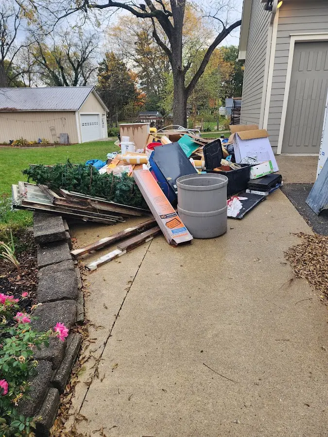 Dumpster being loaded with debris for 12 Yard Dumpster Rental in Cordele